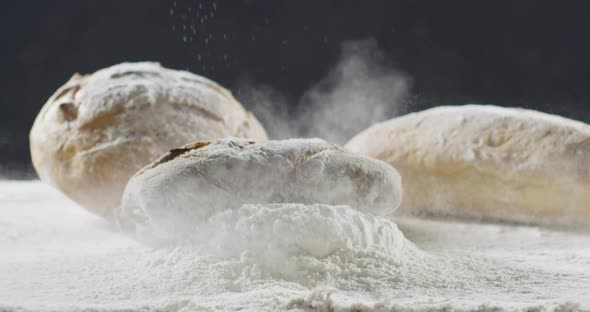 Bakery and Cooking Concept. Fresh Bread with a Splash Falls Into Flour alt