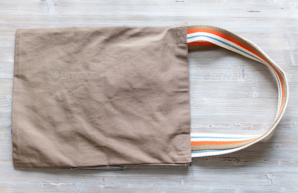 brown fabric double handles sling Bag on gray