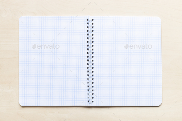 open blank spiral notebook on light brown board Stock Photo by