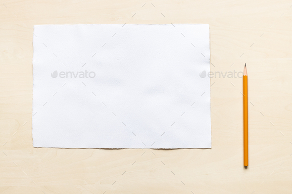 wooden pencil near blank sheet of white paper Stock Photo by vvoennyy