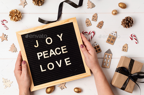 Felt letter board with text joy, peace, love and christmas gifts, decoration