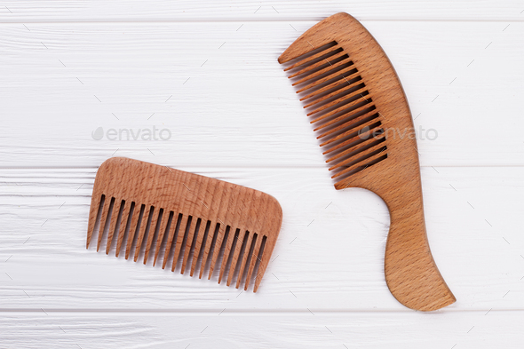 Wooden hair combs on white background.