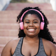 Premium Photo  Sport curvy black woman listening music with headphones -  focus on face