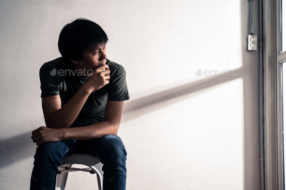 Asian male unemployed worker sitting on chair feeling stress that have no job due to covid-19