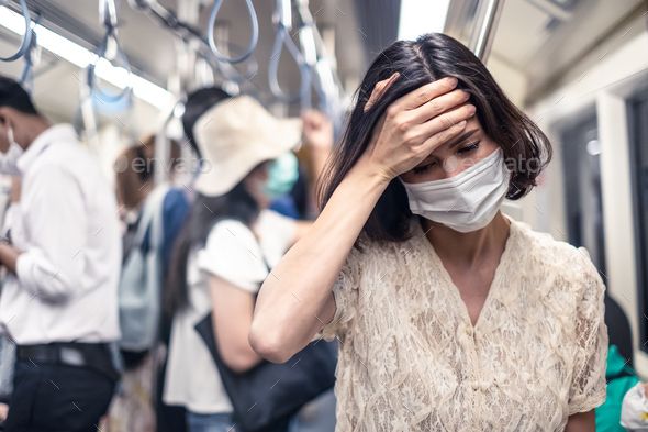 Asian people standing in sky train protecting coronavirus outbreak by wear mask. - Stock Photo - Images