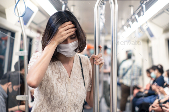 Asian people standing in sky train protecting coronavirus outbreak by wear mask. - Stock Photo - Images