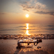 Message in the bottle against the Sun setting down - PhotoDune Item for Sale