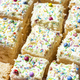 Sliced Sponge Cake DEcorated With Cream and Sprinkles. Closeup View - PhotoDune Item for Sale