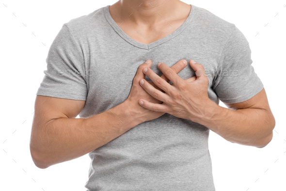 Cropped millennial european muscular male suffering from chest pain, presses hand to sore spot - Stock Photo - Images
