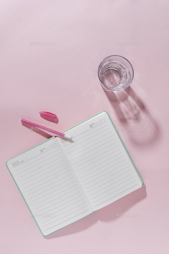 Pink feminine office workspace still life with open journal