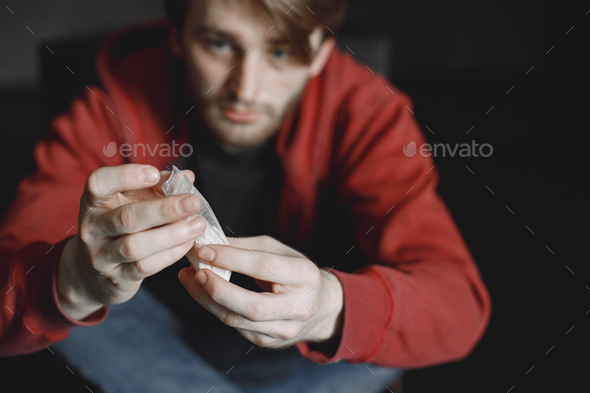 Young addicted man with cocain packet sitting alone Stock Photo by ...