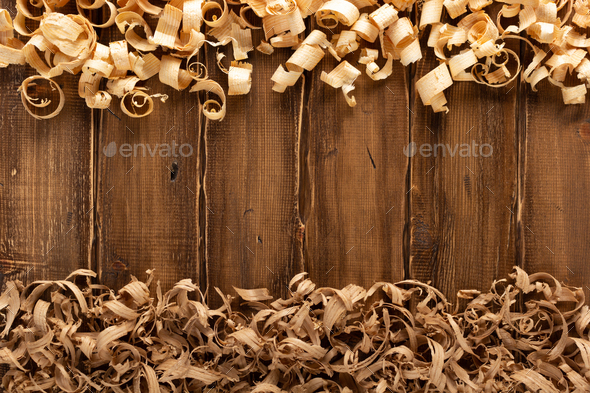 Wood shaving on table background. Wooden shaving at old plank board texture  Stock Photo by seregam