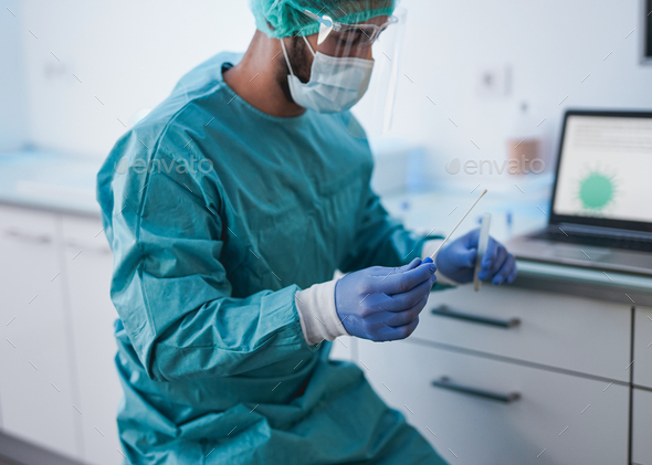 Medical doctor holding cotton nose swab test inside hospital