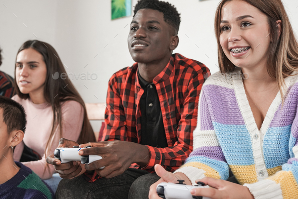 Multiracial young people playing video games at home - Generation z ...