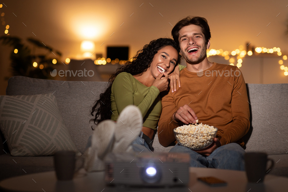 Spouses Laughing Watching Comedy Film Eating Popcorn Sitting Indoors