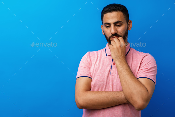 Arab man thinking hard against blue background