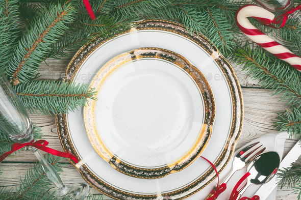 Wooden table with pine tree branches and holiday table setting Stock ...