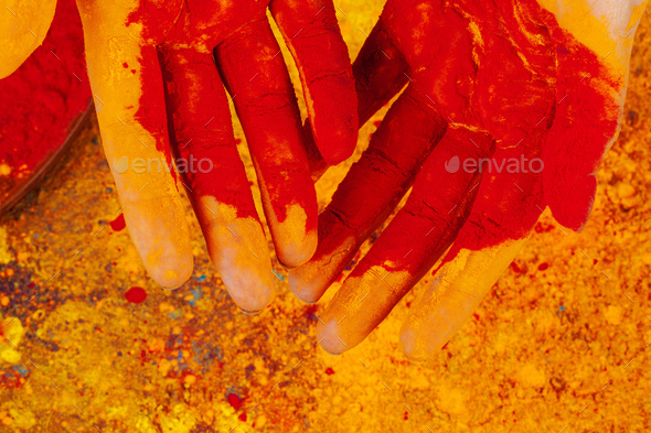 Hands holding Holi powder paint, view from above
