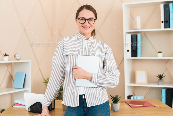 Businesswoman freelancer boss working in office, holding digital tablet. New idea, startup, deadline