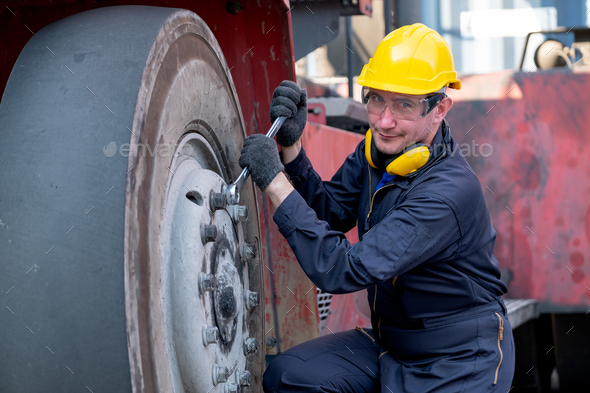 Cargo container technician or worker use wrench to fix problem about truck tire