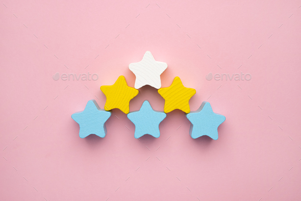 Top view on children's educational games, frame from multicolored kids toys on pink