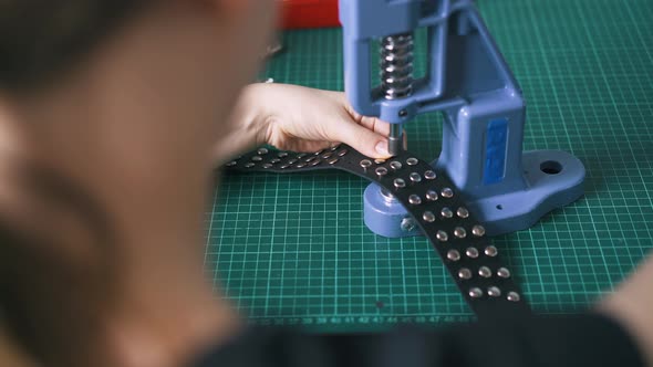 Woman Sets Metal Accessories on Black Leather Choker alt