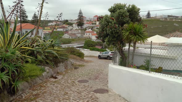 Walking Downhill in Azenhas do Mar Village with Beautiful View of Area in Background