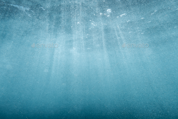 Underwater blue background in ocean with sunbeams Stock Photo