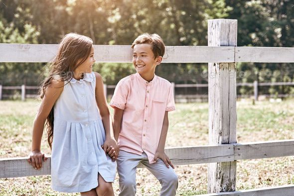 Friendship. Little Boy And Girl Walking Together Outdoors Leanin Stock ...