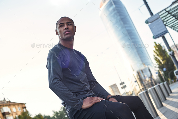 Fitness is the way of life. Close up portrait of thoughtful young african male resting during urban