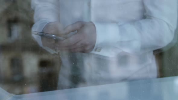 Bankrupt Businessman Scrolling Web Pages on Smartphone, Looking for Job, Crisis alt