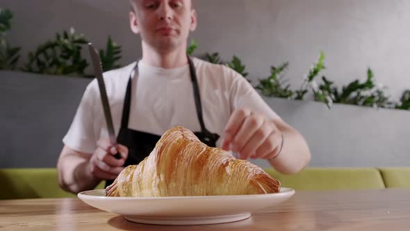 Baker Cuts Fresh Crispy Croissant and Shows the Filling the Berry Filling Close Up alt