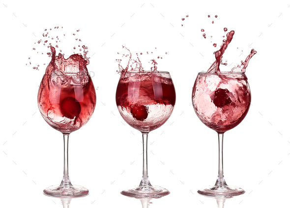 red wine swirling in a goblet wine glass, isolated on a white background