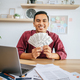 a man working in an office and holding money. - PhotoDune Item for Sale