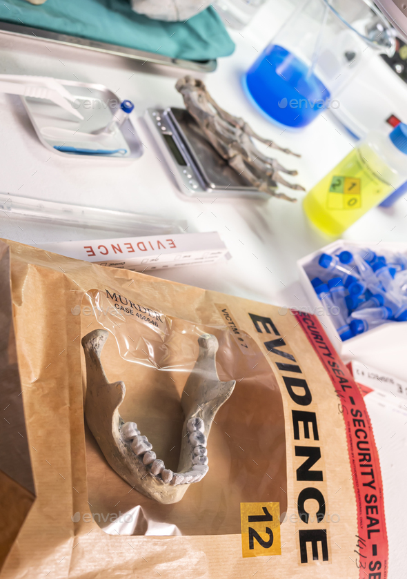 Evidence bag with human lower jaw in forensic lab murder investigation, conceptual image