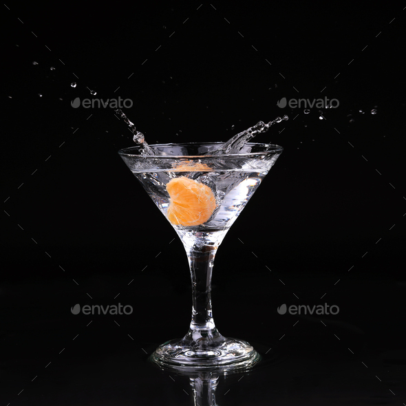 martini cocktail splashing into glass on black background Stock Photo