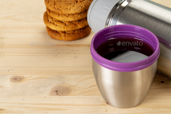 Aluminum metal thermos container bottle close up on table Stock
