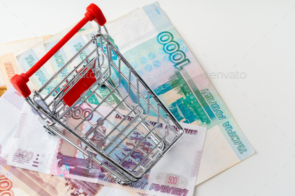 Toy shopping cart with Russian rubles money. Living wage and purchasing power concept - Stock Photo - Images