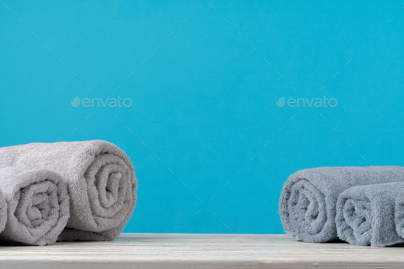 Stacked clean fluffy towels in a bathroom Stock Photo by FabrikaPhoto