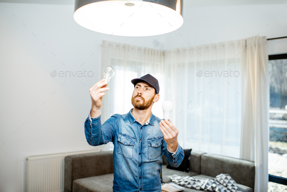 Man changing lamps in the apartment