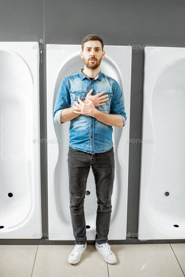 Man with bathtub in the plumbing shop