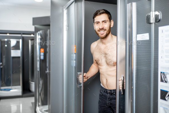 Naked man in the shower cabin in thhe shop Stock Photo by RossHelen