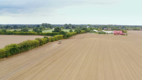Aerial view of an agriculture field with tractor alt