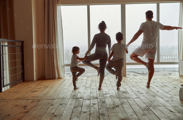 Fit family doing yoga together during quarantine