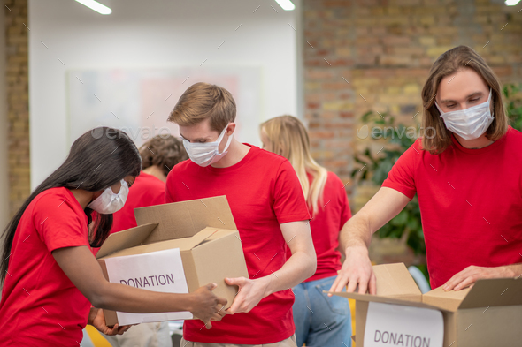Young volunteers in red tshirts at work in a distribution point