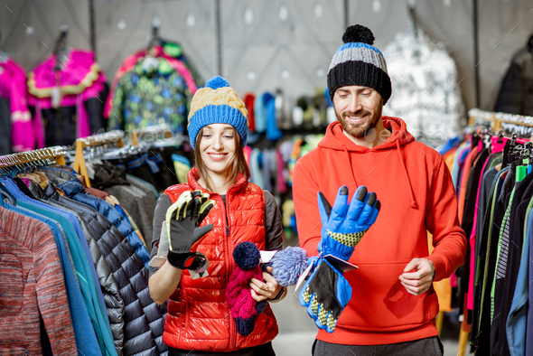 Couple trying winter clothes in the shop