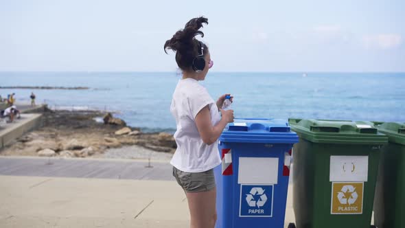 Slim Young Sportswoman Running on Coast Beach Throwing Empty Water Bottle on Plastic Waste Bin and alt