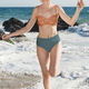 Happy woman in bikini at the beach on her vacation full body portrait - PhotoDune Item for Sale