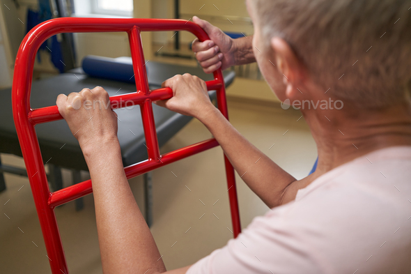 Shot of mature woman with walking disability in rehab center