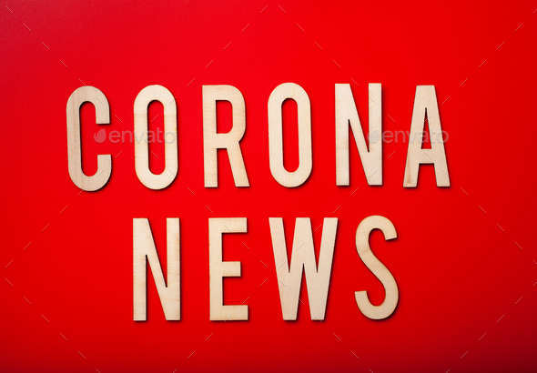 corona news word text wooden letter on red background corona virus covid-19